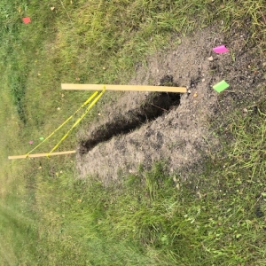 Straight trench excavated near a field